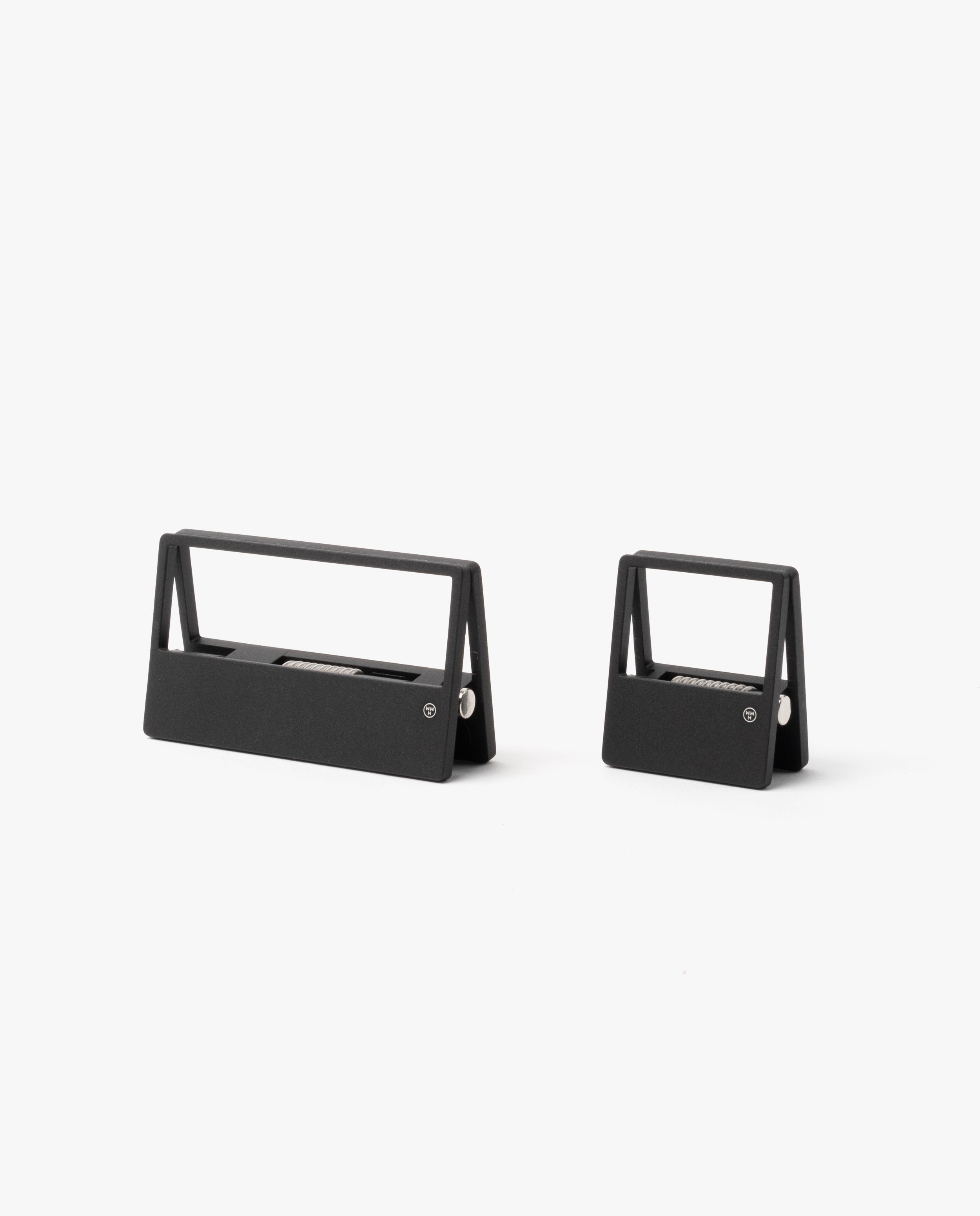 Two modern, minimalist black staple removers in different sizes sit side by side on a plain white background—a sleek addition to any desk organizer paired with your HMM Clips (Set of 2 - Black).