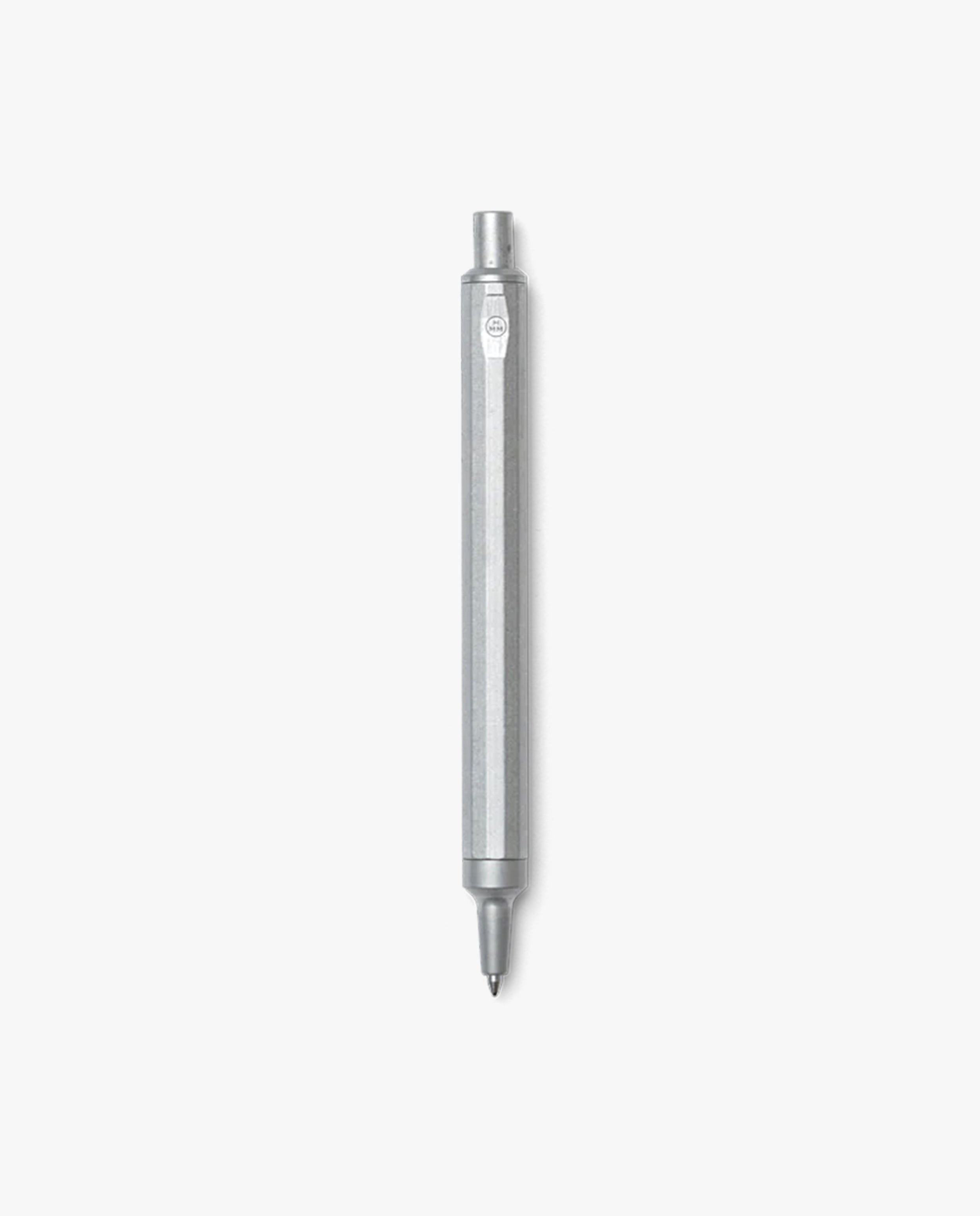 The HMM Ballpoint Pen (Raw), featuring a sleek aluminum body with a hexagonal barrel and a click-top mechanism, is displayed vertically against a plain white background.