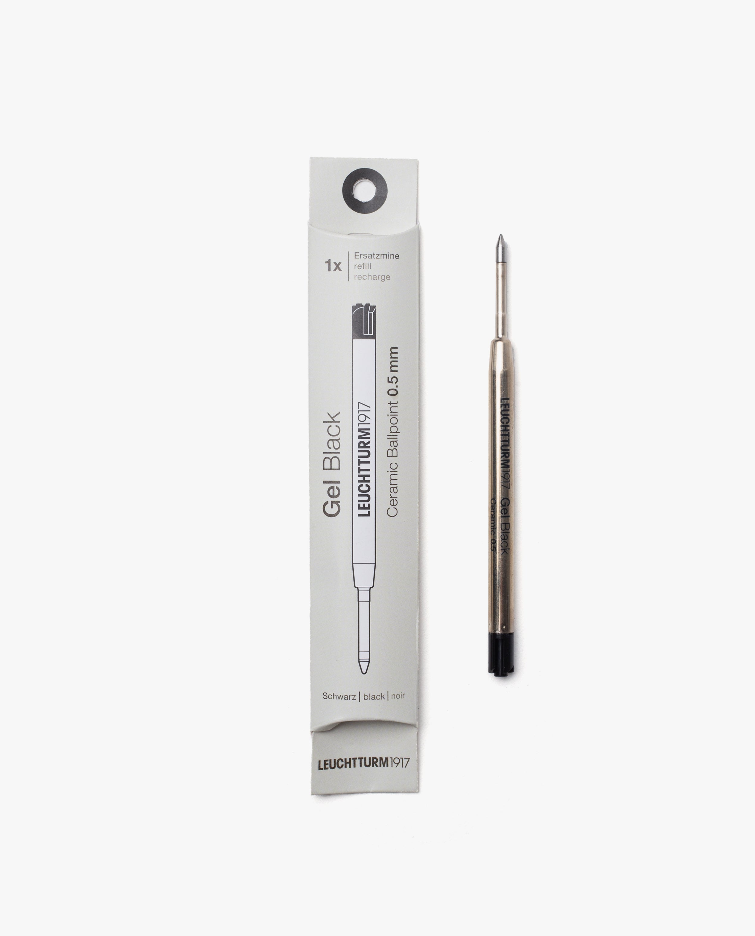 A Black Gel Pen Refill (The Ugmonk Pen) is displayed next to its white packaging. The 0.5mm metallic refill has a black end, and the box shows product details in black text along with an illustration of the refill.