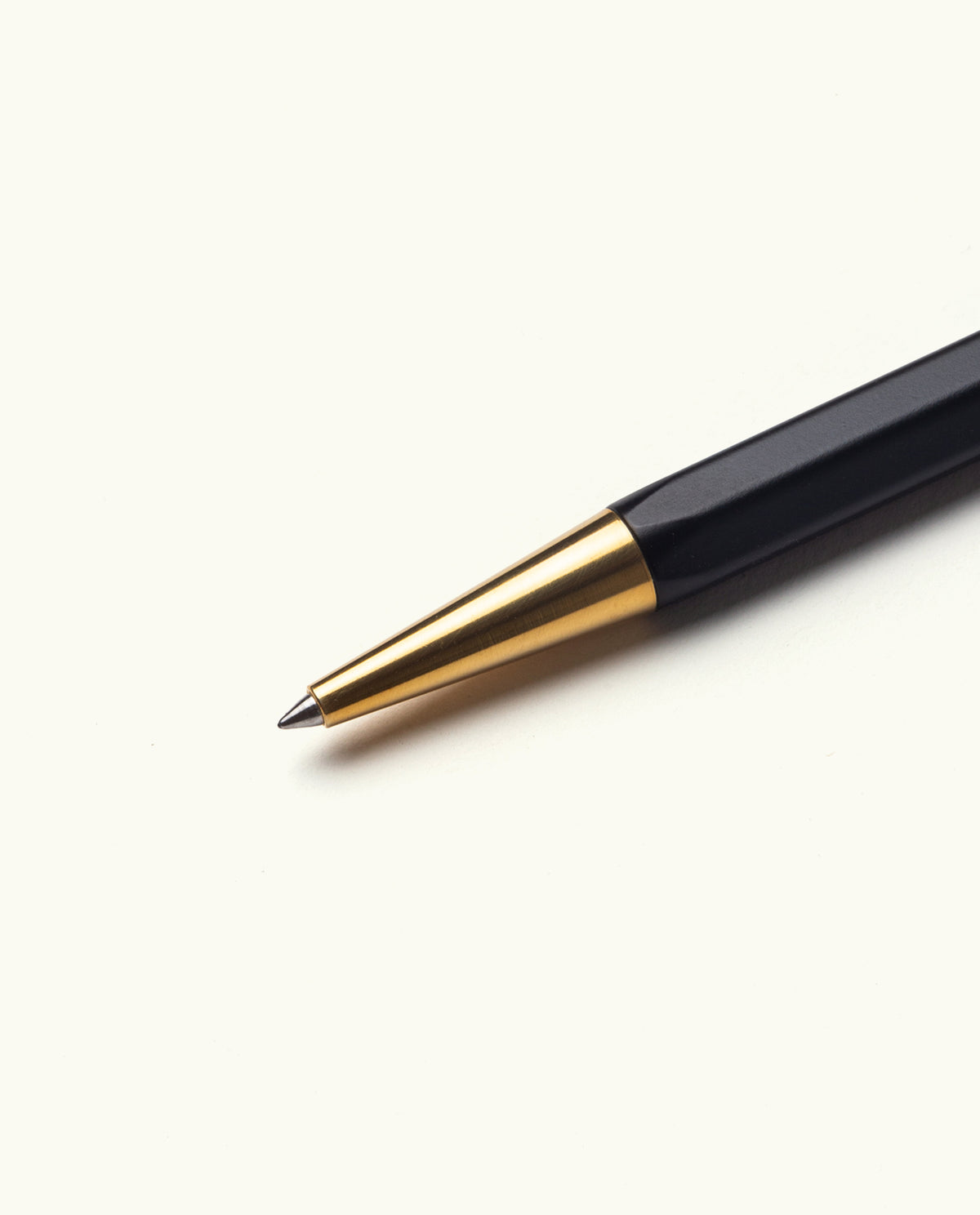A close-up of The Ugmonk Pen (Leuchtturm1917 Drehgriffel - Black) with a gold tip, displayed diagonally on a plain white background.