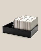 An Analog Archive (Black Aluminum) featuring a black tray, an analog card organizer, a stack of indexed cards, and metal dividers.