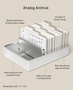 Analog Archive (Silver Aluminum) solid card organizer holding a stack of index cards with twelve divider tabs, featuring a sliding mechanism and non-slip base, measuring 5.5 inches by 7 inches by 1.4 inches.