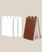 The Leather Discbound Analog + 3 Refills (Brown) stands upright beside three stacks of “Today” refill pages with lined notes and checkboxes—a perfect beige-background setup for analog task cards.