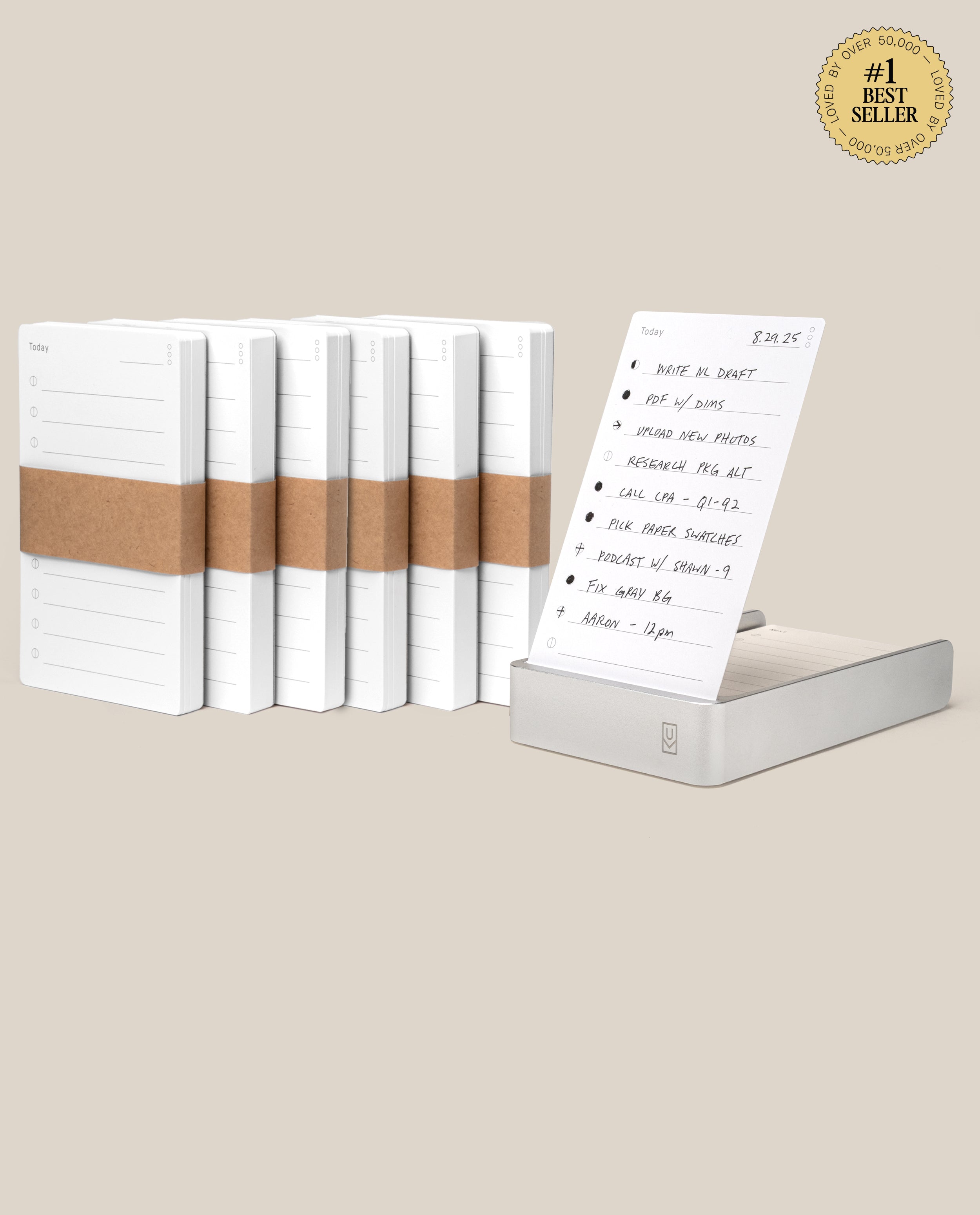 The Analog Daily Focus Kit + 6 Refills (Silver Aluminum) features a stack of notepads with brown paper bands, one notepad on display with a handwritten to-do list, and a #1 Best Seller badge in the top right corner. Perfect for analog productivity.