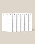 Six white Discbound Analog Refill notepads (6-pack) with blank lines and checkboxes are arranged side by side on a beige background. Each notepad features a top cutout, ideal for hanging, binding, or use as discbound refill cards.