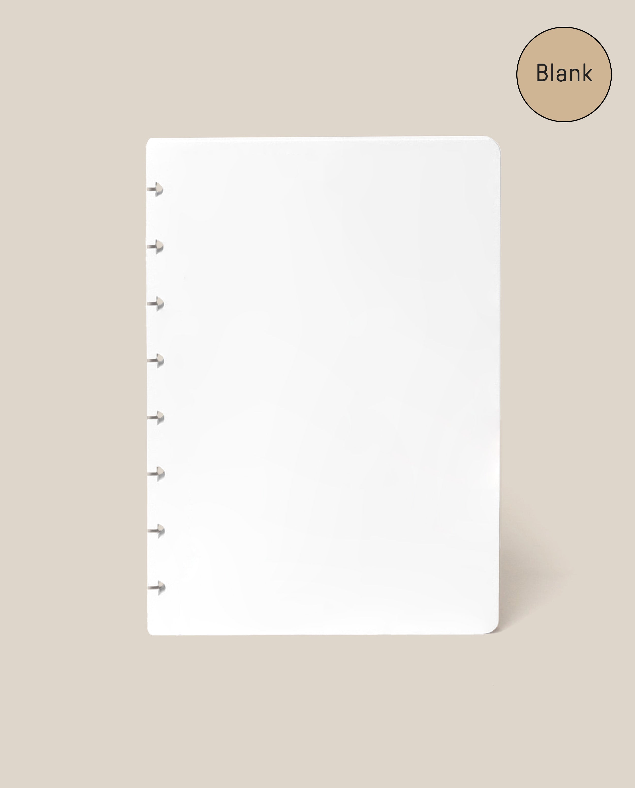 A smooth, blank white page of paper with disc binding on the left, set against a beige background. A circle in the top right corner reads “Blank”—making this Discbound Journal Refill - Blank (Standard 6″ x 8.5″) the ideal replacement paper pack for your Heirloom Discbound Journal.