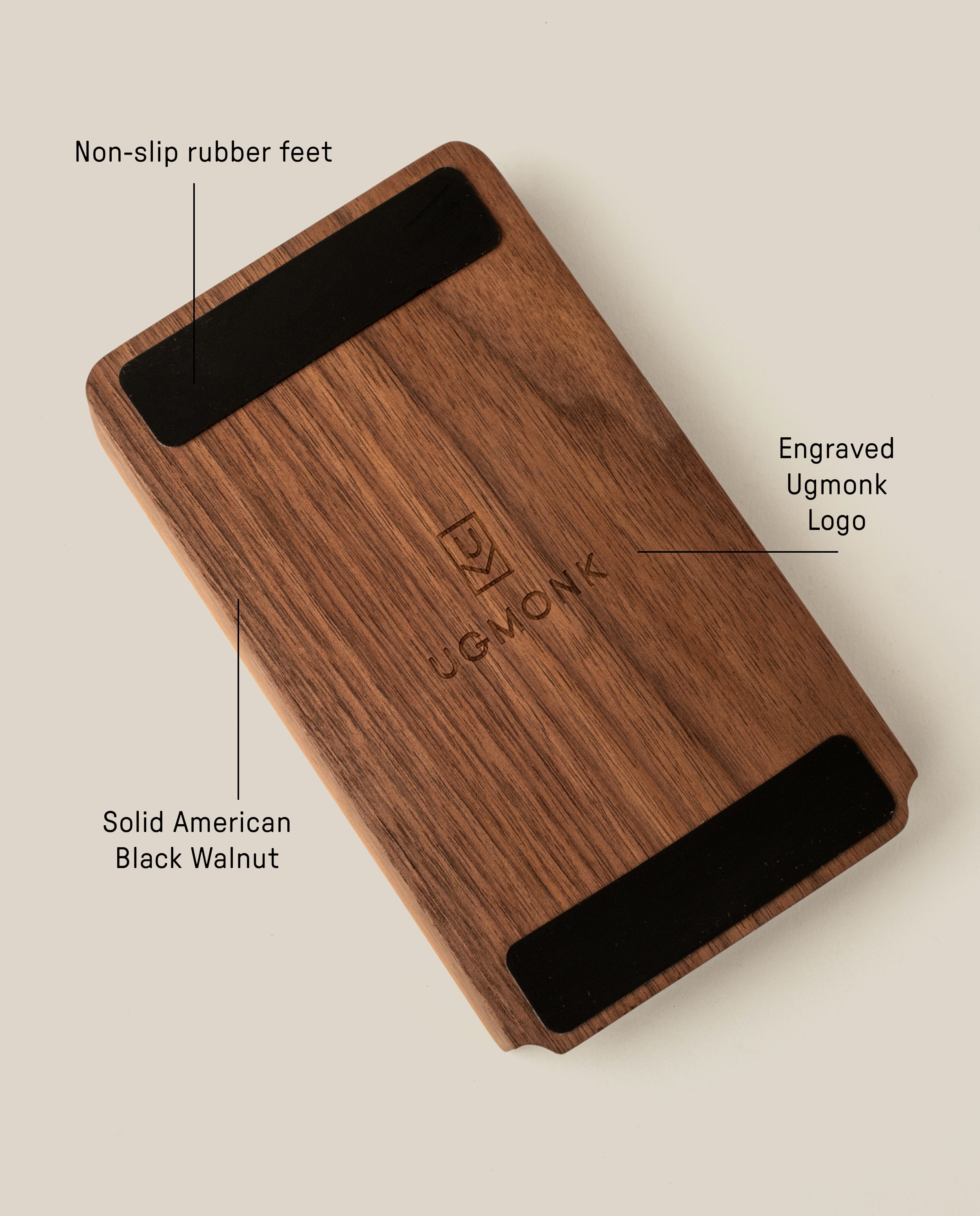 The Analog Daily Focus Kit (Walnut) is a rectangular solid American black walnut card holder with an engraved Ugmonk logo at the center and two black non-slip rubber feet on opposite underside edges.