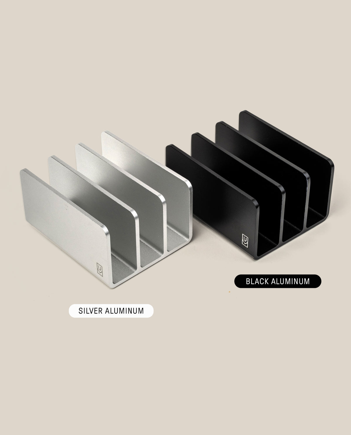 Two Analog Card Organizer trays—one silver, one black aluminum—each with three slots, are displayed side by side on a beige background. Labels indicate SILVER ALUMINUM and BLACK ALUMINUM card trays.