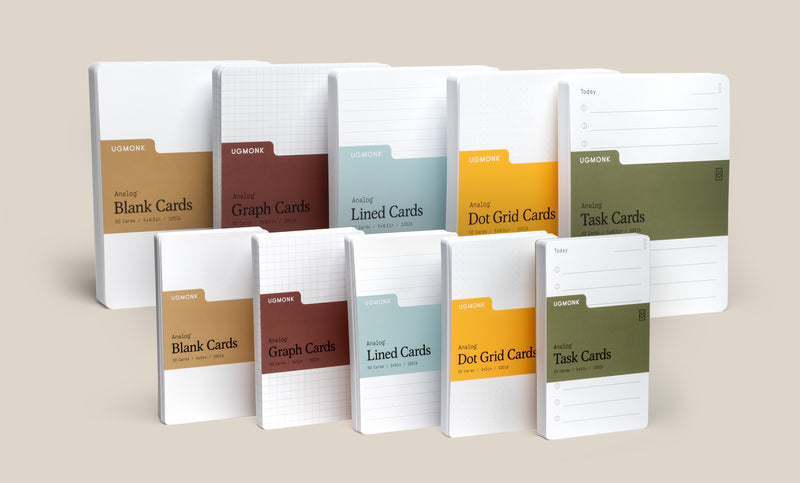 Nine stacks of assorted notecards in different colors and labels, including Blank Cards, Graph Cards, Lined Cards, Dot Grid Cards, and Task Cards, all standing upright against a neutral background.