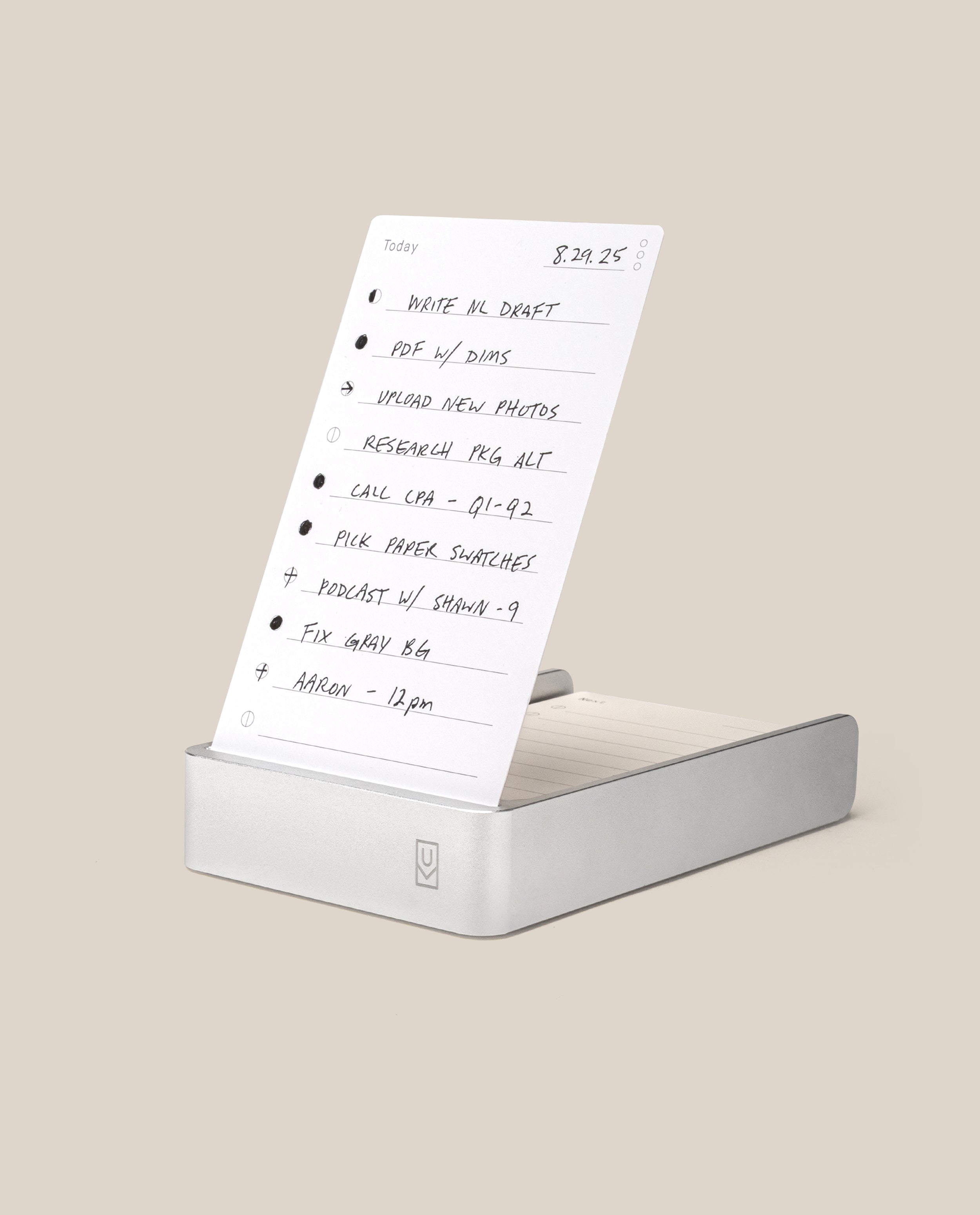 The Analog Daily Focus Kit (Silver Aluminum) is a minimalist productivity system with handwritten task cards for reminders like writing, uploading photos, making calls, and recording podcasts in a sleek aluminum card holder.