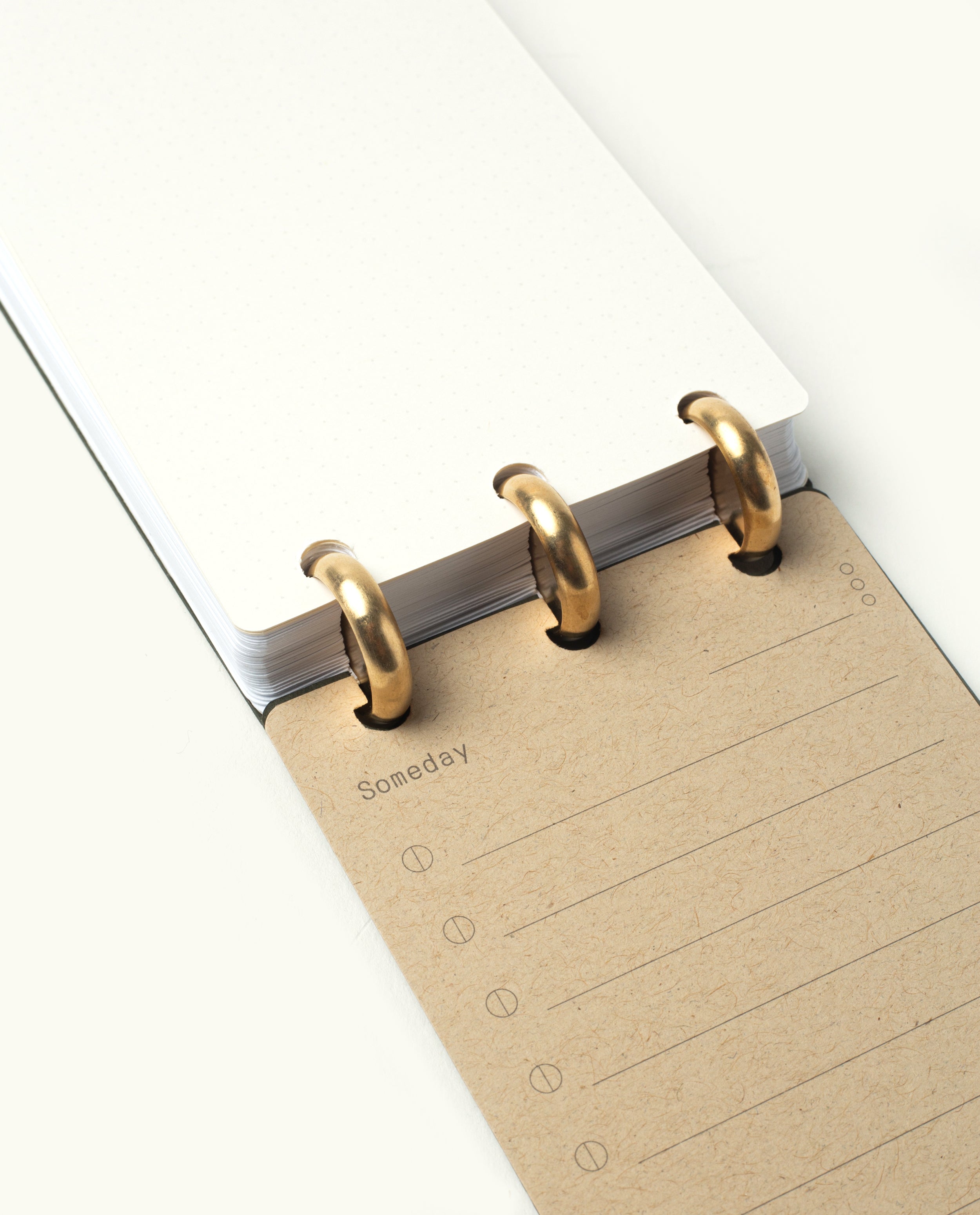 The Discbound Analog + 3 Refills features gold rings, a blank dotted grid page on top, and a lined brown "Someday" page with note icons underneath—ideal for flexible, refillable task planning.