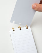 A hand opens the Discbound Analog + 3 Refills, featuring a dotted translucent cover and brass disc binding. Inside, a "Today" page offers lined circles for tasks—making it your ideal refillable daily task planner.