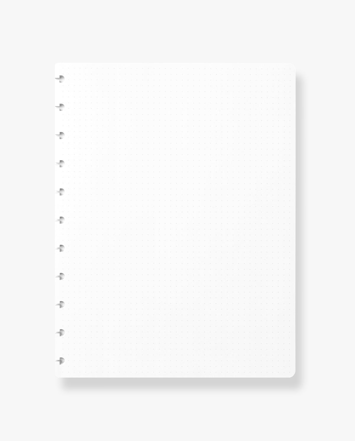 The Discbound Journal Refill (8.5" x 11") features a blank, white dot grid notebook page with left-side spiral binding, set against a light background—ideal for refilling your discbound journal and enhancing your note-taking experience.