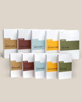 The Analog Card Variety Pack features twelve Ugmonk notepads—blank, graph, lined, dot grid cards—and Task Cards, neatly arranged upright in two rows on a neutral background.