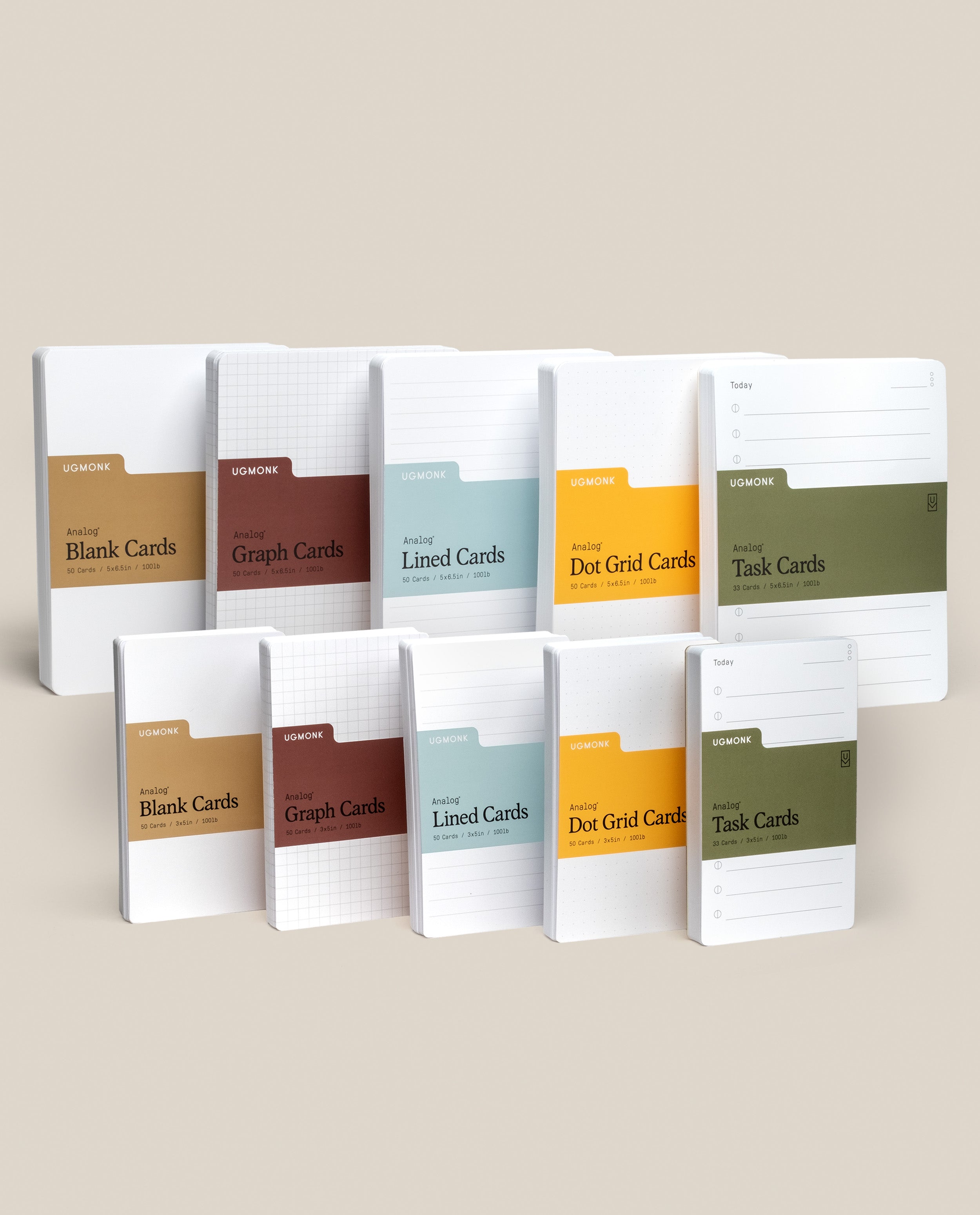 The Analog Card Variety Pack features twelve Ugmonk notepads—blank, graph, lined, dot grid cards—and Task Cards, neatly arranged upright in two rows on a neutral background.