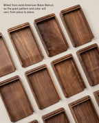 Several Analog Daily Focus Kit (Walnut) trays made from solid American Black Walnut are arranged on a light surface, displaying unique grain patterns; ideal as wooden card holders for task cards in an analog productivity system.