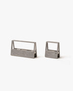 The HMM Clips (Set of 2 - Raw) feature sleek, open-frame aluminum designs—one large and one small—resting on a white background. Ideal as modern organizers for your workspace or stylish paper clips.