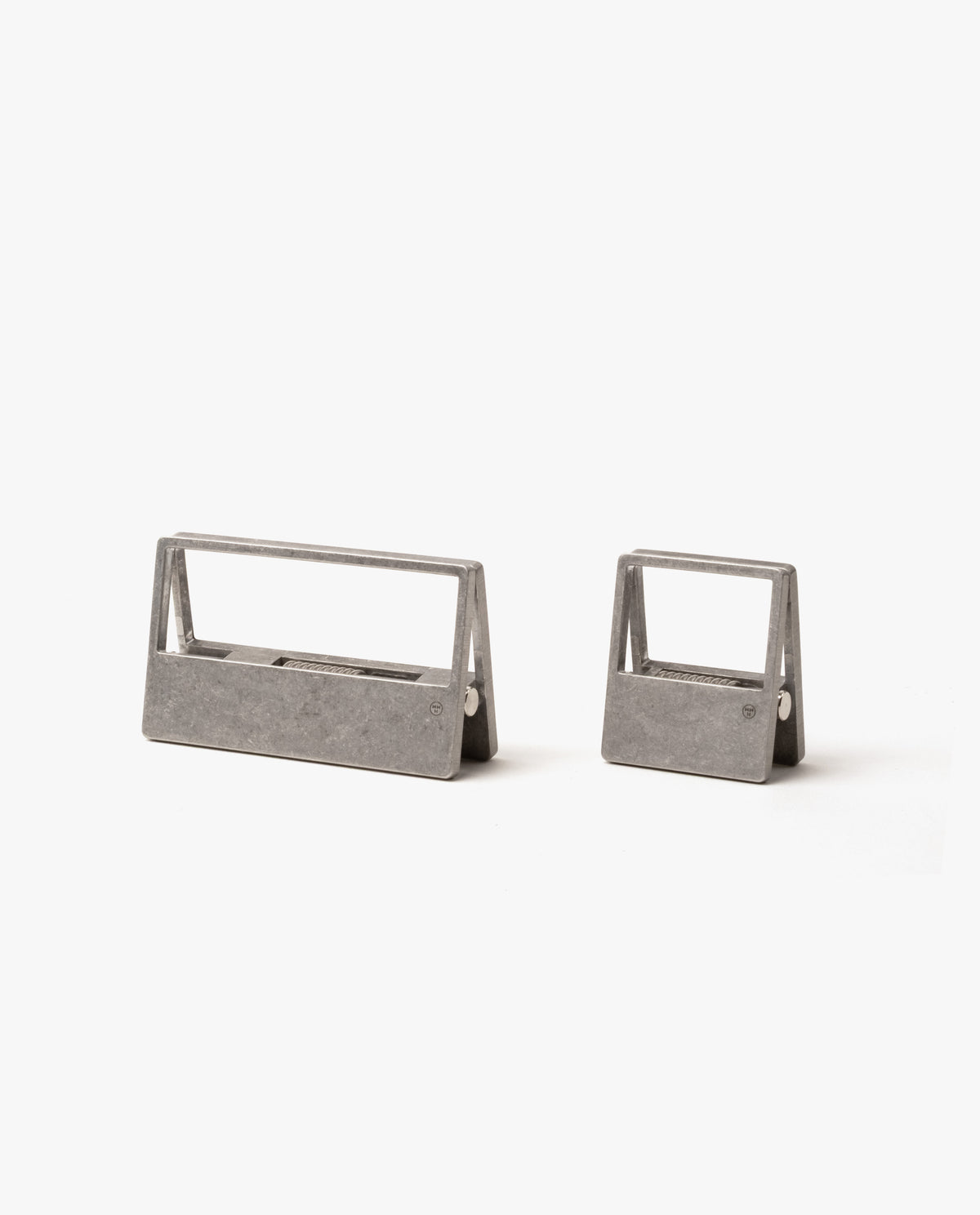 The HMM Clips (Set of 2 - Raw) feature sleek, open-frame aluminum designs—one large and one small—resting on a white background. Ideal as modern organizers for your workspace or stylish paper clips.