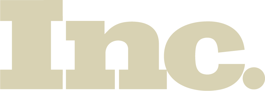 Large, bold, beige letters spelling Inc. on a light gray background.