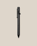 An INVENTERY Bolt Action Pen (Onyx) with a clip is centered on a plain beige background, its sleek black Cerakote ceramic coating providing both durability and style.