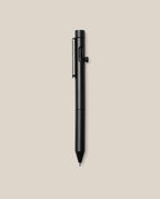 An INVENTERY Bolt Action Pen (Onyx) with a clip is centered on a plain beige background, its sleek black Cerakote ceramic coating providing both durability and style.