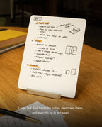 A Large Dot Grid Card from the Analog Starter Kit - BOGO Special, featuring handwritten notes, bulleted lists, and sketches under the title “Day 2,” is displayed upright on a stand atop a wooden table. Text below reads: Large Dot Grid Cards for notes, sketches, ideas—perfect for any paper card system or task cards.
