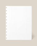 A Large Discbound Journal Refill - Dot Grid (8.5″ x 11″) sheet, featuring a square white page with round discbound holes along the left edge, is displayed against a light beige background.