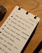 The Leather Discbound Analog + 3 Refills (Black) displays a to-do list with tasks such as team call, send CAD, rewrite video script, call insurance, export product photos, finalize dates, reimburse travel, and a meeting with Charles at 3pm.