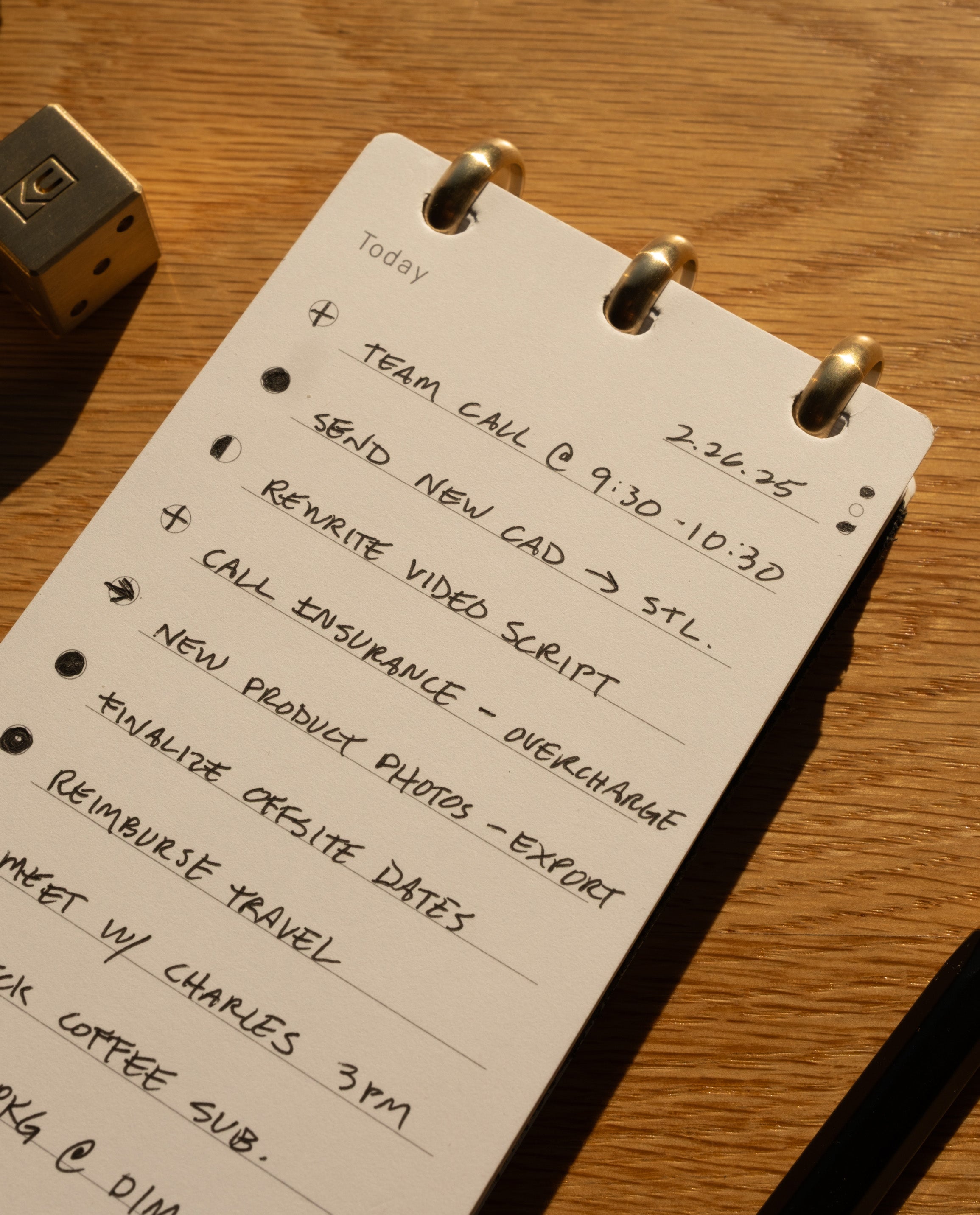 The Leather Discbound Analog + 3 Refills (Black) displays a to-do list with tasks such as team call, send CAD, rewrite video script, call insurance, export product photos, finalize dates, reimburse travel, and a meeting with Charles at 3pm.