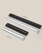 A slim, rectangular Analog Card Bar (Small 10" - Black) desk organizer rests on a beige background, alongside silver and large-size options.