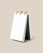 The Discbound Analog, a compact white refillable task organizer, rests open on a beige surface to a fresh “Today” page—ideal for anyone who enjoys working with an analog productivity system.