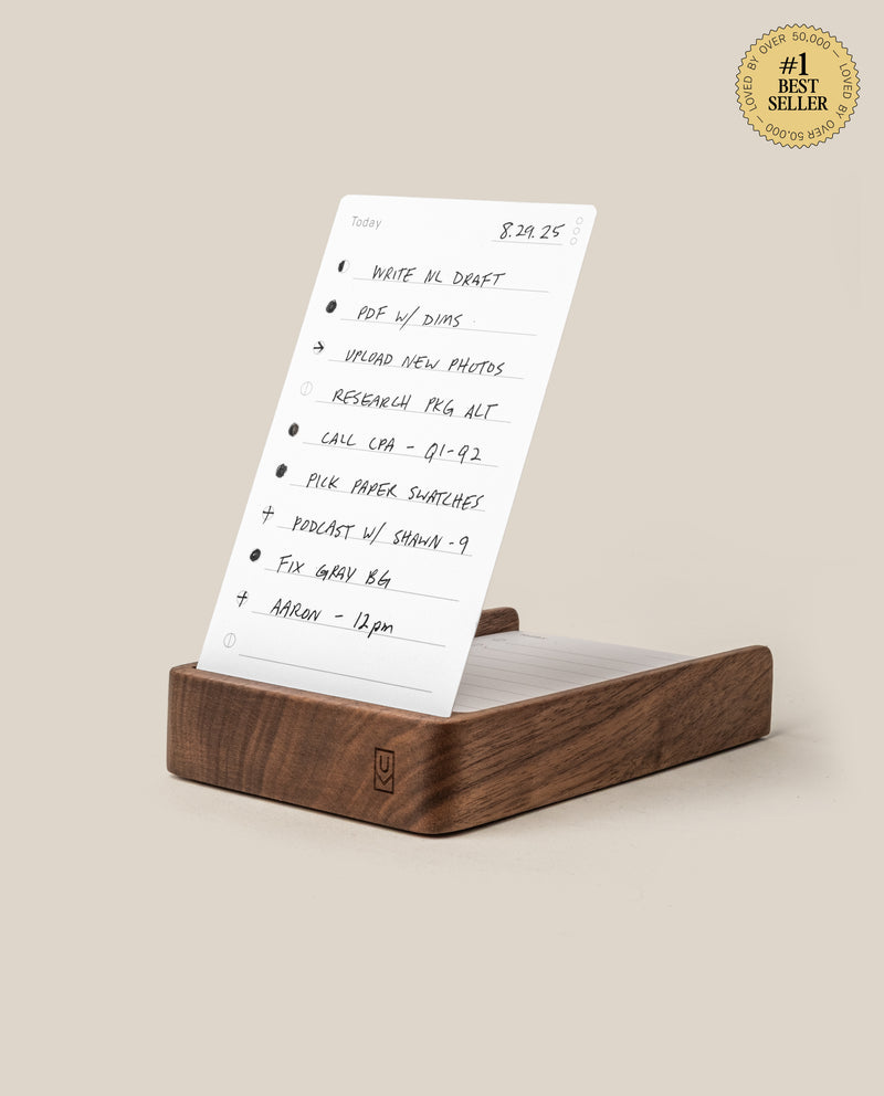 The Analog Daily Focus Kit (Walnut) holds a handwritten to-do list card with bullet-pointed tasks for elegant, analog productivity. A gold #1 Best Seller badge appears in the top right on a beige background.