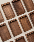 Rectangular walnut trays with raised edges are arranged neatly, highlighting the rich wood grain—perfect for organizing your Analog Annual Kit (Walnut) and showcasing its warm tones on a light surface.