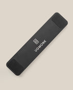 The Analog Pen Tray (Black Aluminum) is a sleek, rectangular aluminum organizer with rounded corners, black pads on both ends, and features the Ugmonk logo and text in white. It rests on a light beige surface.