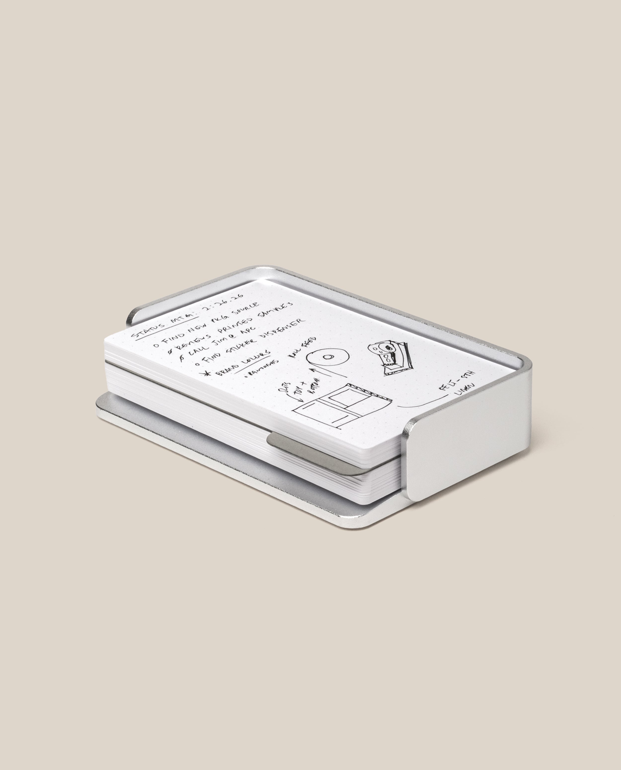 The Analog Capture Kit - Small (Silver Aluminum) features Dot Grid Cards with handwritten notes and sketches neatly arranged in a sleek aluminum tray, creating a stylish workspace accent on a beige background.