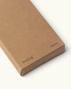 A brown cardboard box labeled "Analog" and "Someday," designed to hold Analog - Someday Cards (3-Pack) made from uncoated paper, is photographed against a plain light background.