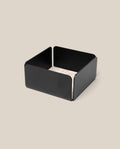 The Warehouse Item - Gather Small Tray (1x1 - Black) features a black, low-sided square design, ideal as a small tray or desk organizer, shown holding a stack of light-colored square coasters atop a beige background.