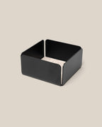 The Warehouse Item - Gather Small Tray (1x1 - Black) features a black, low-sided square design, ideal as a small tray or desk organizer, shown holding a stack of light-colored square coasters atop a beige background.