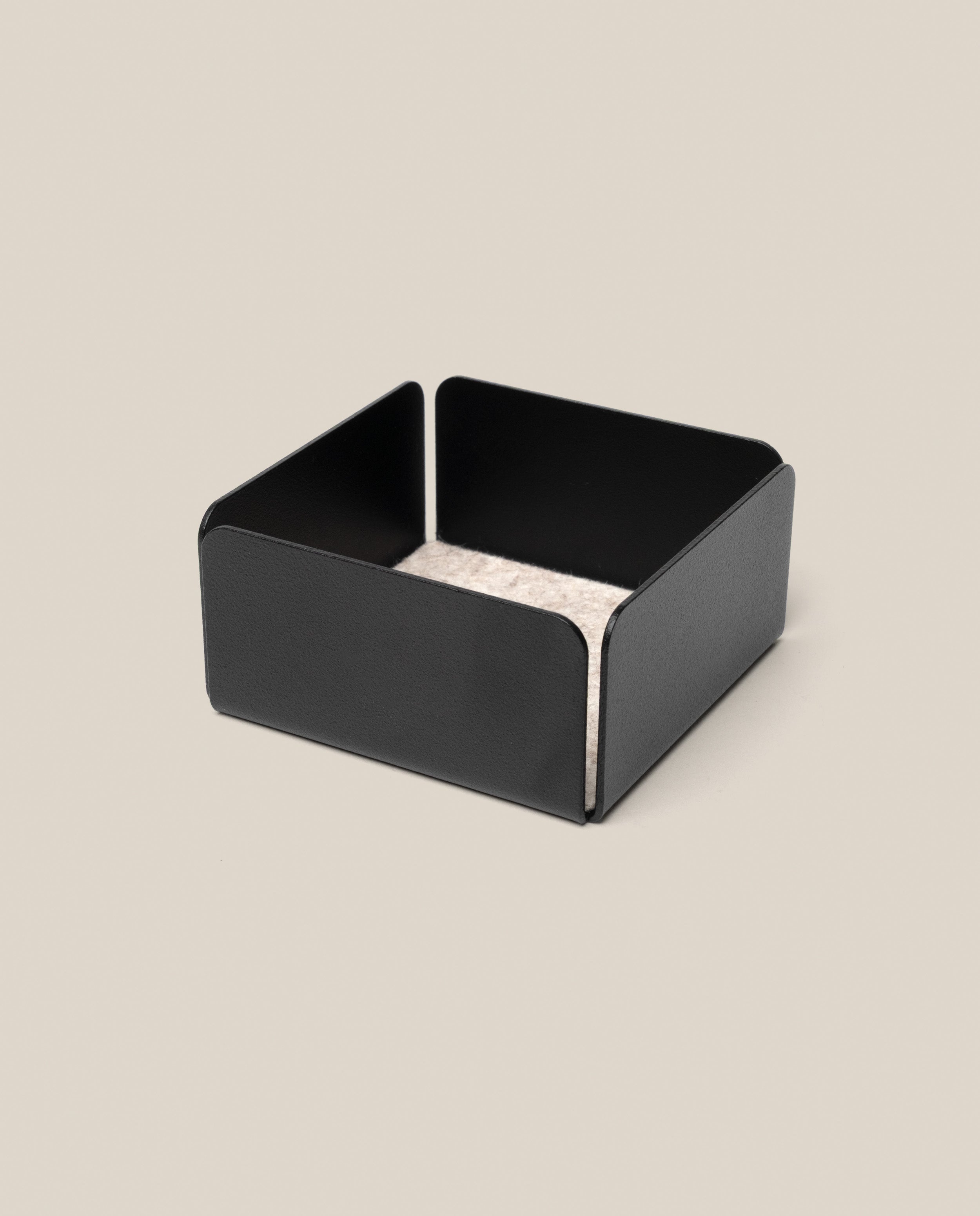 The Warehouse Item - Gather Small Tray (1x1 - Black) features a black, low-sided square design, ideal as a small tray or desk organizer, shown holding a stack of light-colored square coasters atop a beige background.
