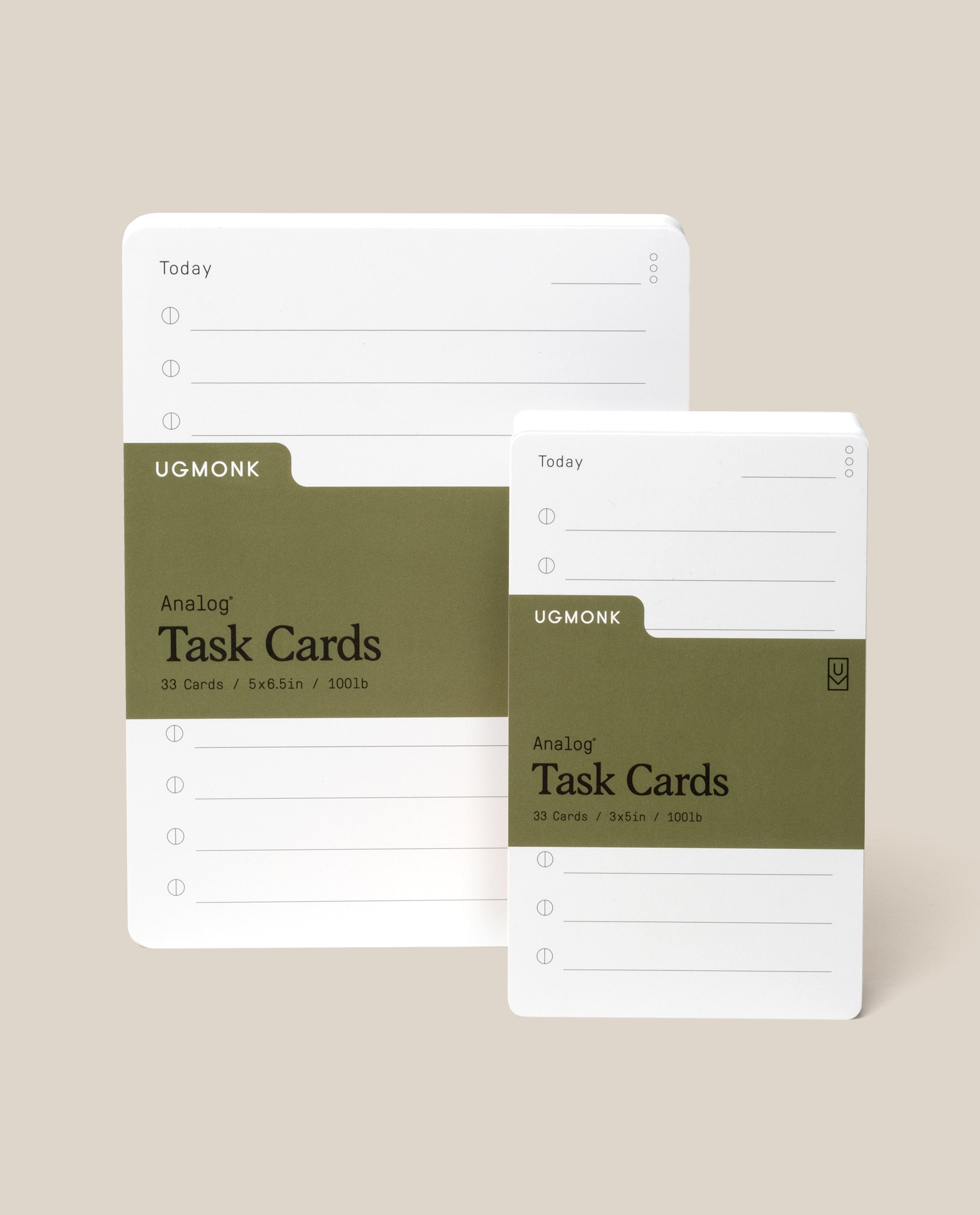 Two sets of white UGMonk Analog Task Cards with olive green labels; one set is larger than the other. Both packs have lines and circles for task lists, displayed on a neutral beige background.