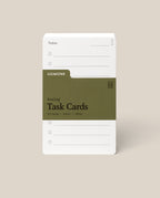 A stack of Analog Task Cards - Small with a minimalist design, made from uncoated 3x5" 100lb cardstock, includes spaces for tasks and a green label showing 33 cards.