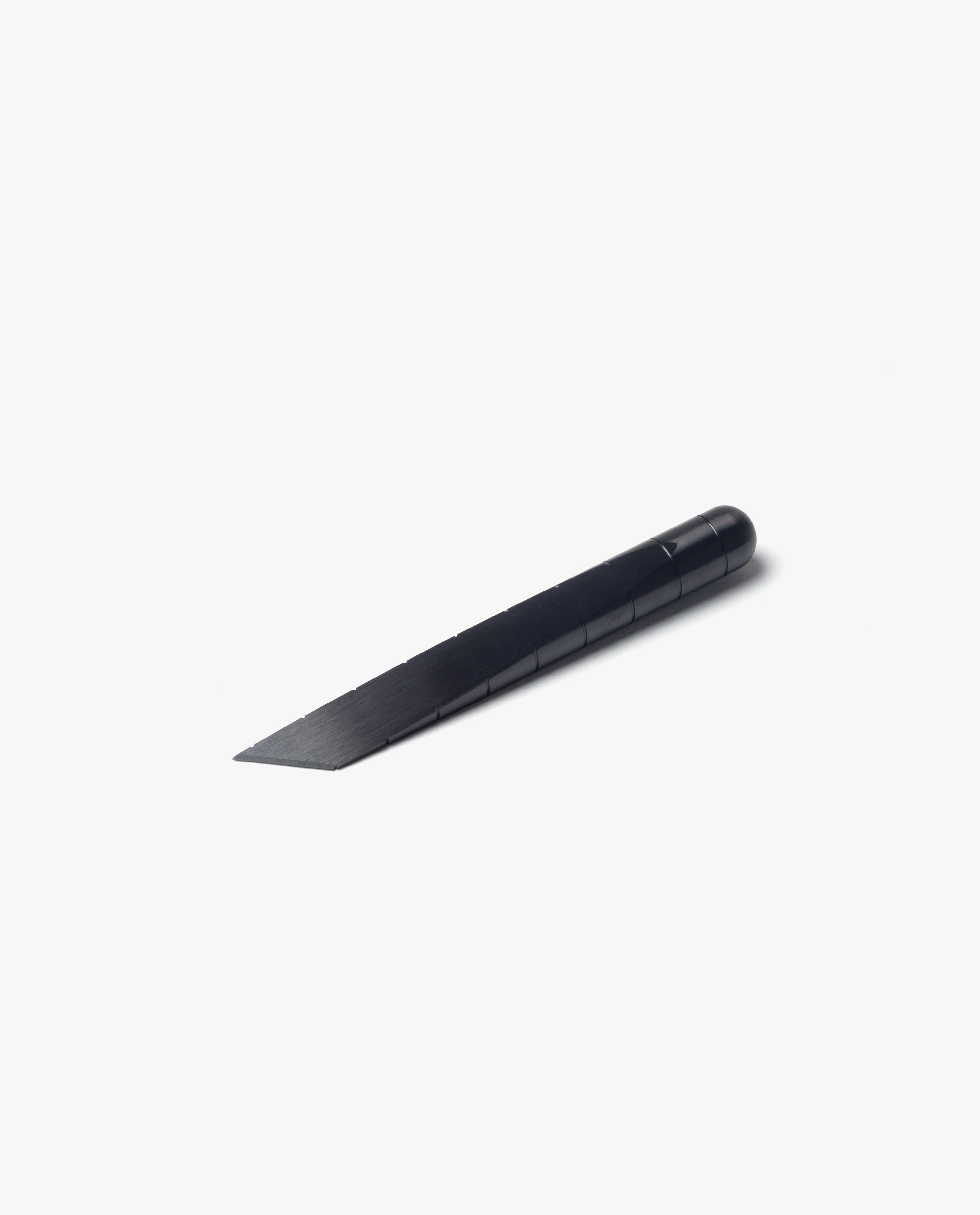 A Craighill Desk Knife (Vapor Black) featuring a straight black handle and a sharp, angled blade lies on a plain white background.