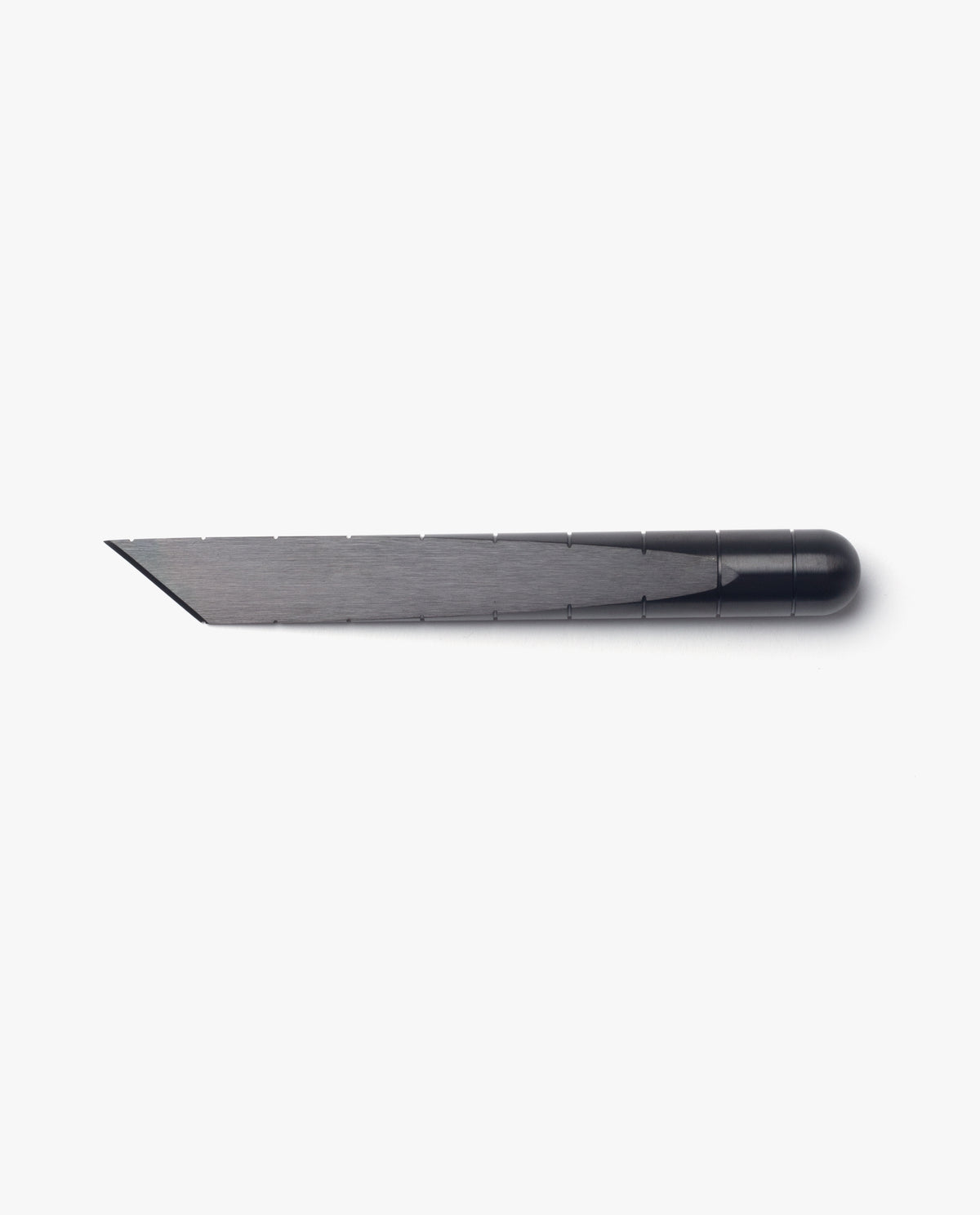 The Craighill Desk Knife (Vapor Black), shown on a white background, features a sleek stainless steel blade held in a black holder and offers precise cutting reminiscent of a Japanese kiridashi knife.
