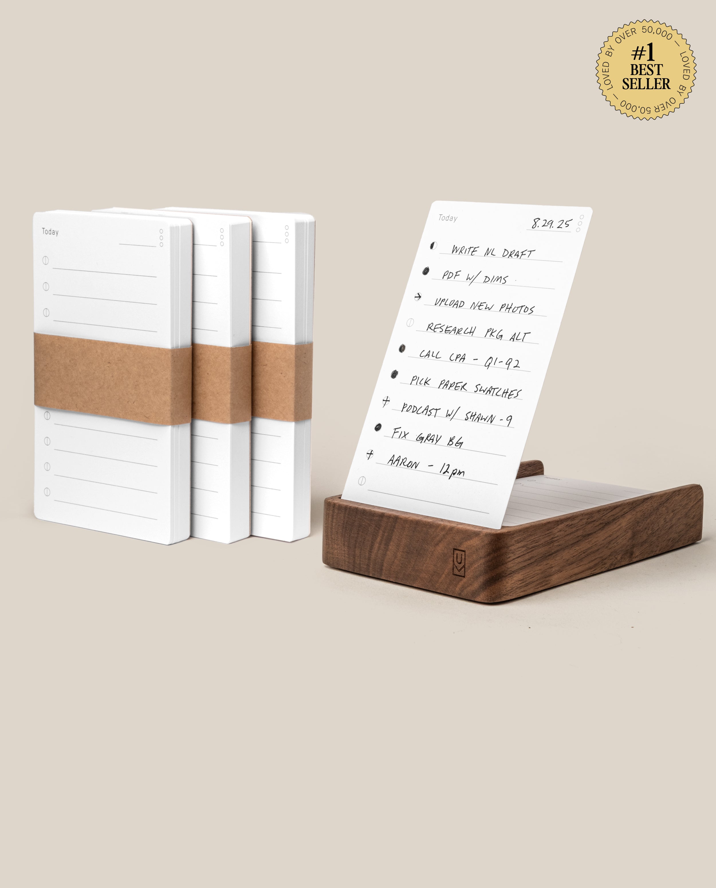 The Analog Daily Focus Kit + 3 Refills (Walnut) features minimalist planner notepads with brown paper bands, a sheet displayed upright in a walnut card holder with a handwritten to-do list, and a #1 Best Seller badge in the top corner.