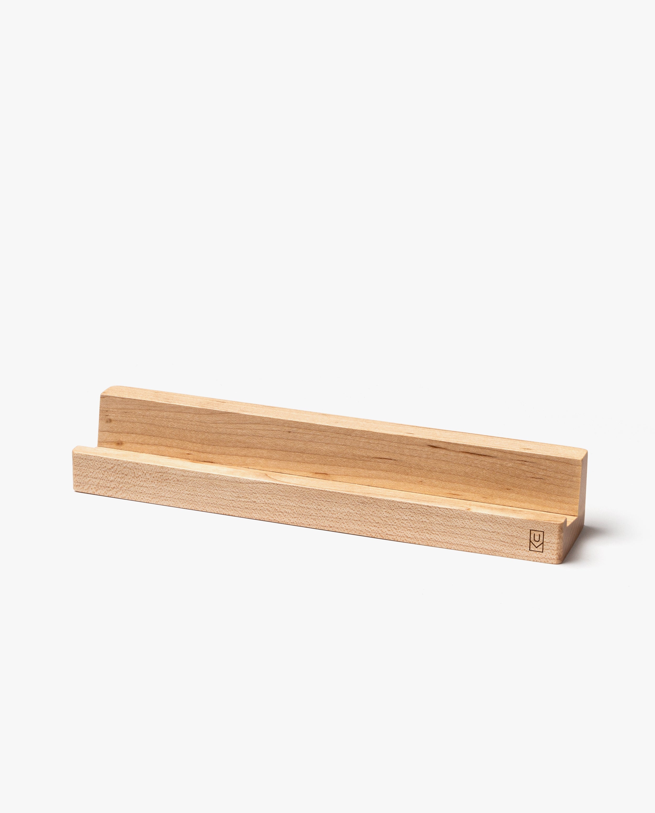 A minimalist, handcrafted maple Analog Weekly Card Holder made in Pennsylvania, featuring a groove to hold items upright. This rectangular, light-colored stand is shown against a plain white background.