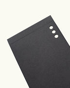 A set of Analog Weekly Cards, featuring black rectangular sheets with three round holes punched along the top right edge, resembling dot grid cards, displayed on a plain white background.