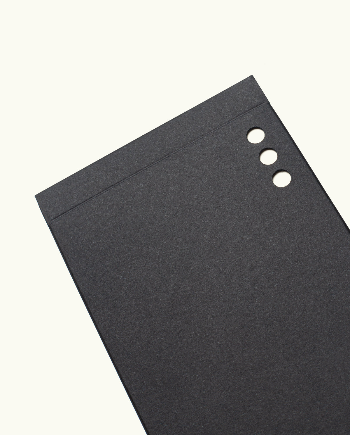 A set of Analog Weekly Cards, featuring black rectangular sheets with three round holes punched along the top right edge, resembling dot grid cards, displayed on a plain white background.
