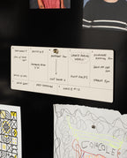 Analog Weekly Cards are pinned to a black wall, displaying handwritten tasks—appointments, calls, inventory planning, and reminders. Below them, colorful drawings and dot grid cards add extra organization and inspiration.