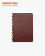 The Warehouse Item - Discbound Heirloom Journal (Brown/Brass), made of full grain leather, is shown with visible creases on the cover. A label reads WAREHOUSE SALE – 50% OFF due to small cosmetic imperfections.