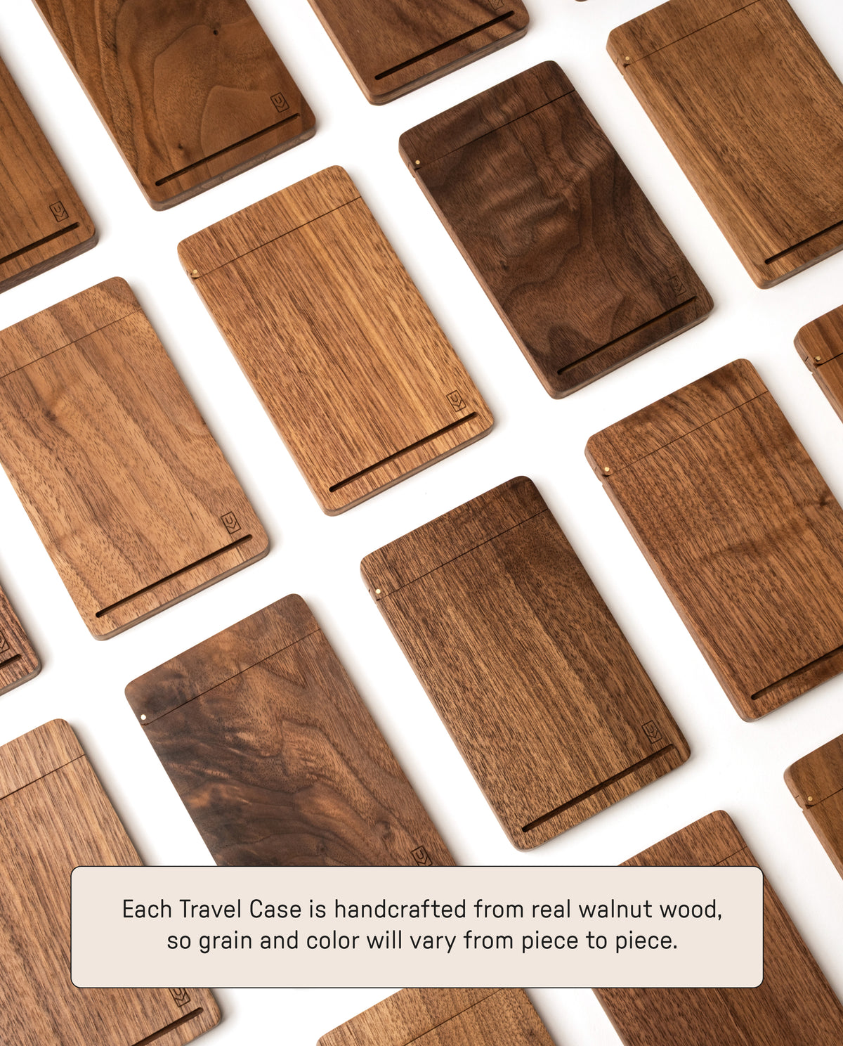 Several Analog Travel Case + 3 Card Packs (Walnut), each handcrafted from real walnut wood with unique grain patterns and shades, are displayed on a white surface. Text below reads: Each Analog Travel Case + 3 Card Packs (Walnut) is handcrafted from genuine walnut wood, resulting in distinctive grain and color variations—ideal for stylishly storing your task cards.